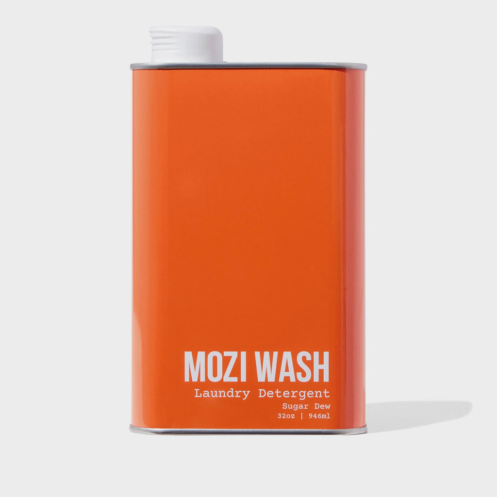 Orange can of Mozi Wash laundry detergent on a white background